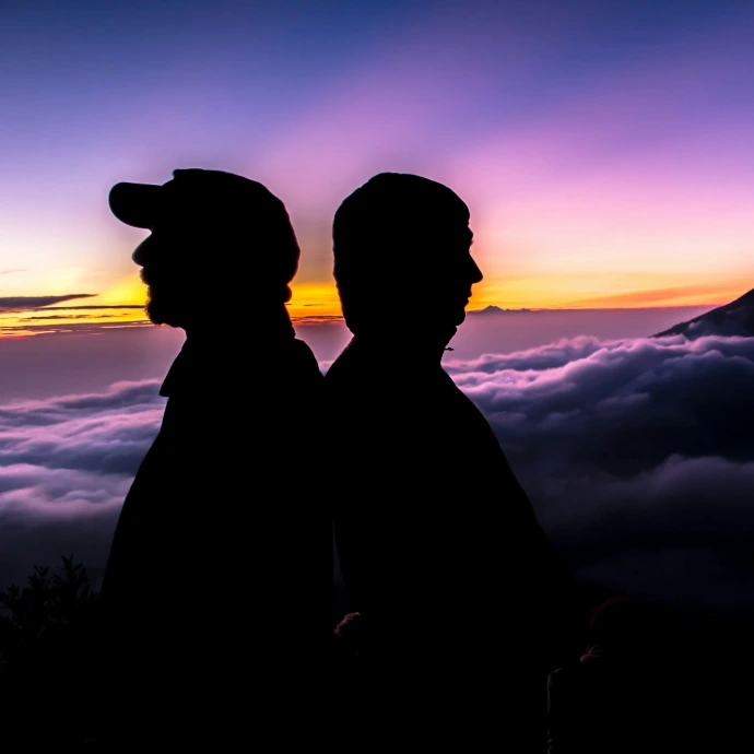 silhouette of men near clouds